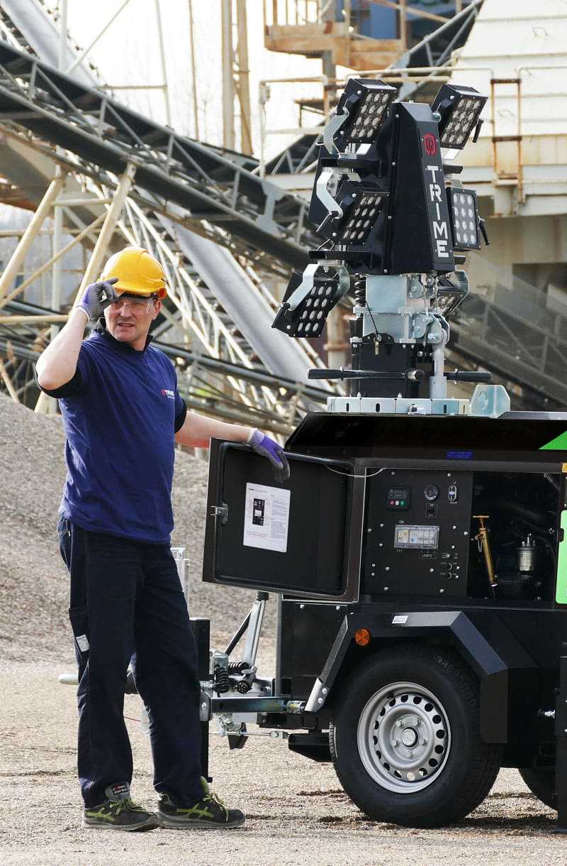 an operator with a Trime Mobile Lighting Tower working in a construction site