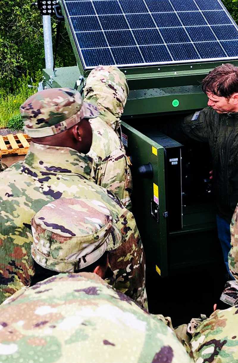 A Solar Hybrid Lighting Tower working with soldier in a military site