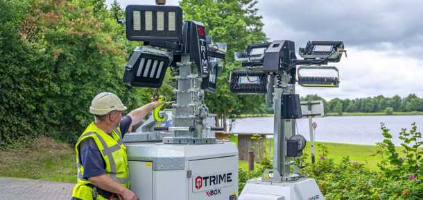 An operator is managing a X-Box full diesel engine lighting tower alongside a X-Smart, plug-in powered Lighting Tower