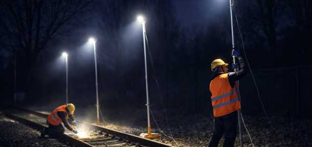 Operators installing Trime X-Rail Kit an illumination kit designed for rail maintenance